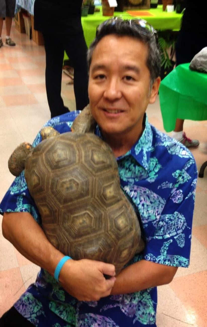 Eric Akaba holding a tortoise