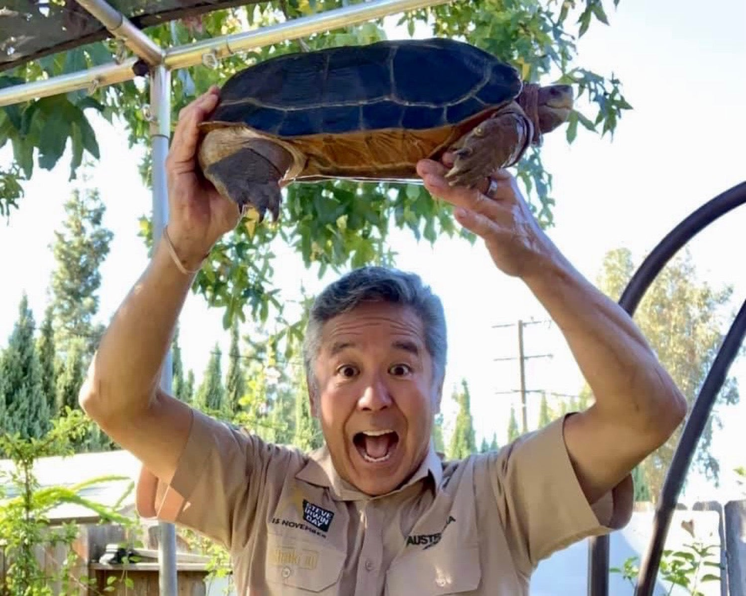 Eric Akaba holding an aquatic turtle he breeds